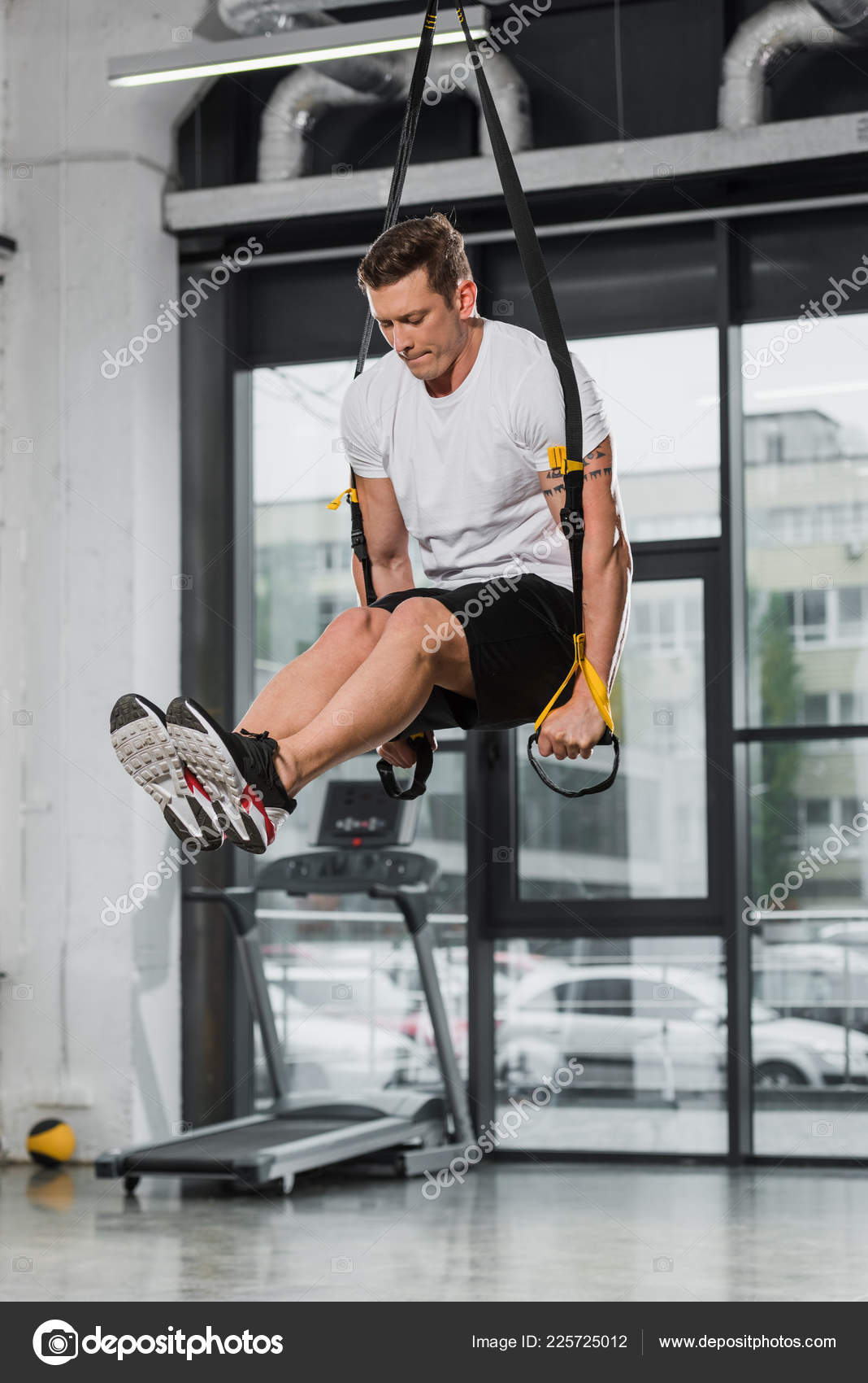 Handsome Athletic Bodybuilder Exercising Suspension Straps Gym Stock