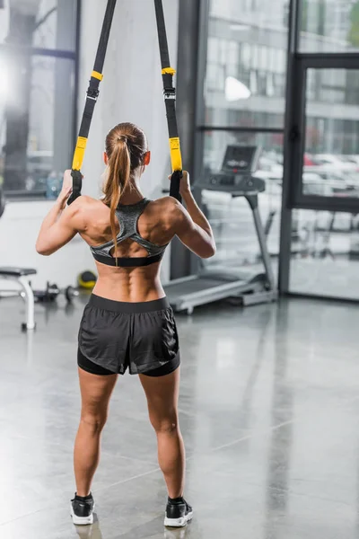 Back View Muscular Sportswoman Working Out Suspension Straps Gym — Stock Photo, Image