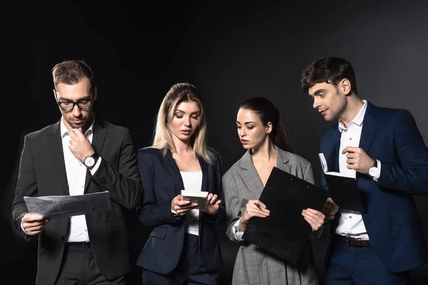 Group Serious Business People Working Various Documents Together Isolated Black — Stock Photo, Image
