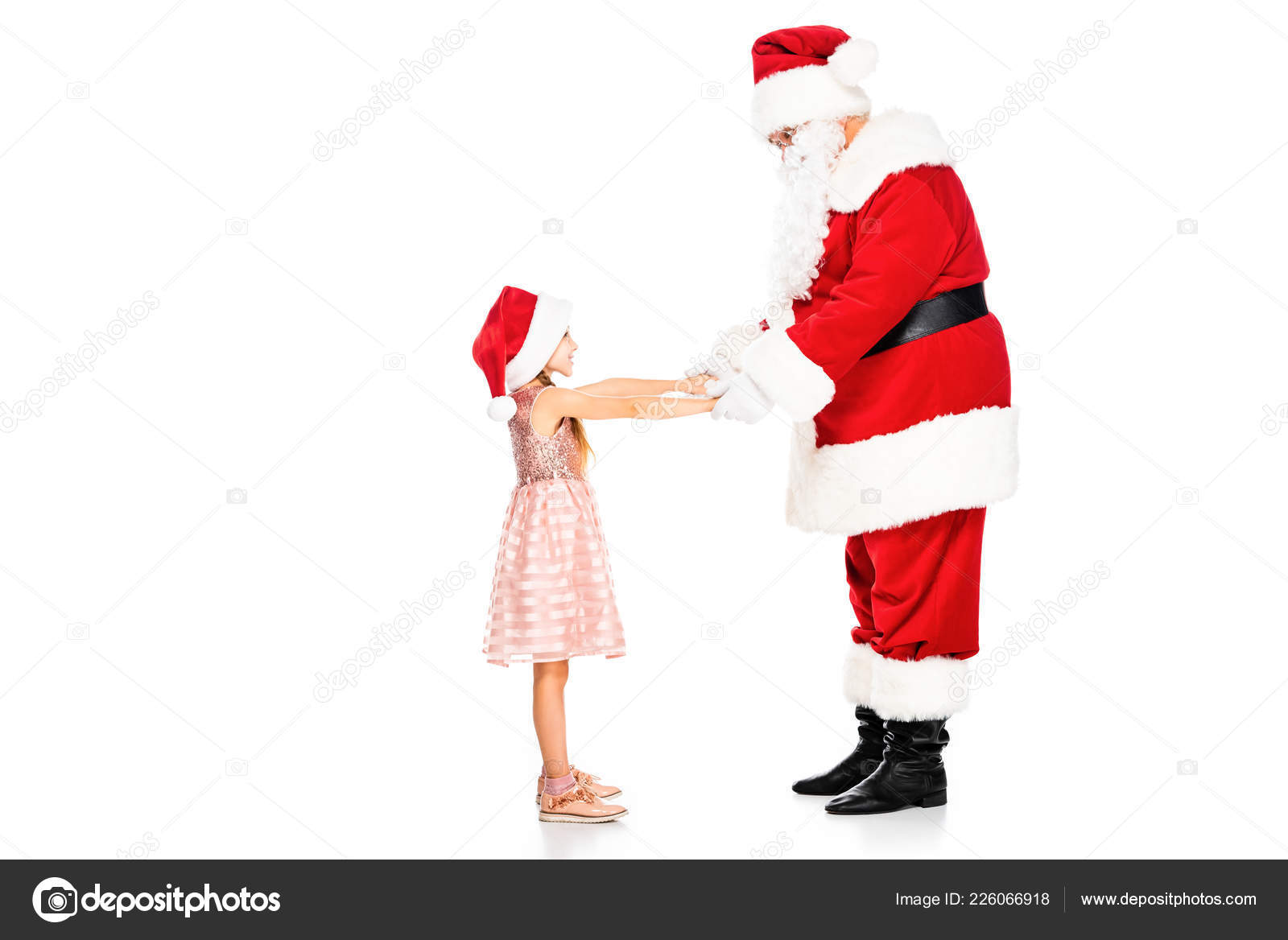 侧视图的圣诞老人和小孩手牵手孤立在白色——图库图片© IgorVetushko #226066918, image size:1600x1168