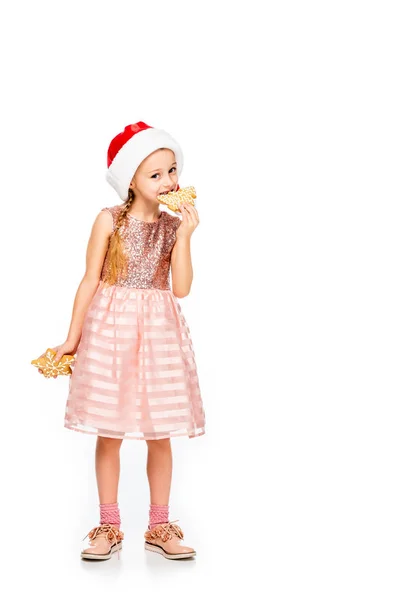 Adorable Little Child Santa Hat Eating Ginger Cookies Looking Camera — Free Stock Photo