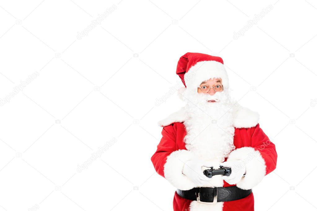 santa claus playing video game with gamepad and looking at camera isolated on white