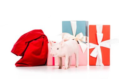 adorable little pig and red bag near christmas presents isolated on white clipart