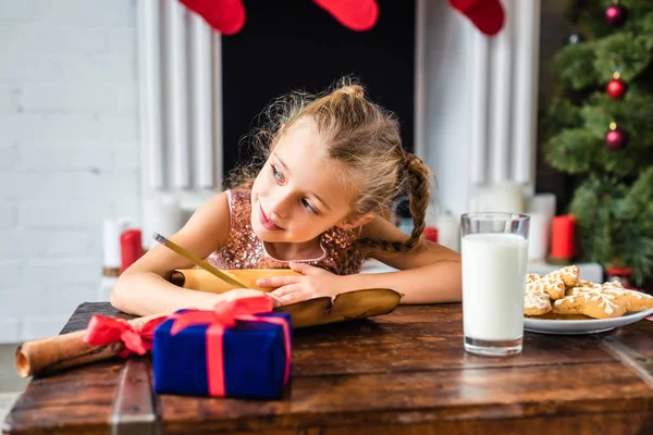 Cute Smiling Child Looking Away While Writing Wishlist Christmas Time — Stock Photo, Image