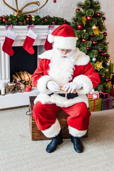High Angle View Santa Claus Holding Rolled Parchment Wish List — Free Stock Photo