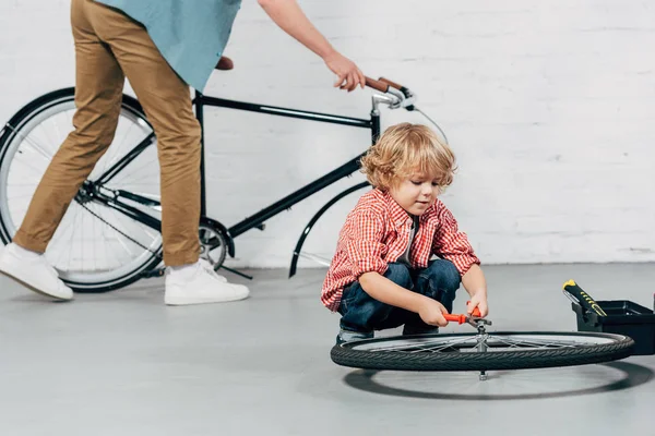 Selective Focus Boy Fixing Wheel Pliers While His Father Standing — Stock Photo, Image