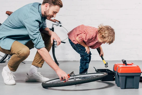 Visão Lateral Reparador Masculino Fixando Roda Bicicleta Com Alicate Enquanto — Fotos gratuitas