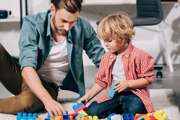 Selective Focus Child His Father Playing Colorful Plastic Blocks Floor — Free Stock Photo