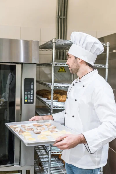 Adult Baker White Chefs Uniform Putting Baking Tray Uncooked Dough — Free Stock Photo