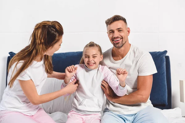 Smiling Parents Tickling Preteen Daughter Bed — Stock Photo, Image