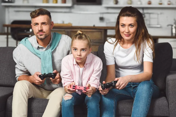 Concentrated Family Sitting Sofa Playing Video Game — Free Stock Photo