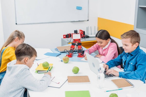 attentive children working at STEM robotics lesson