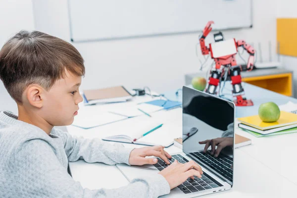 Concentrated Schoolboy Typing Laptop Keyboard Programming Mechanical Robot Stem Class — Stock Photo, Image