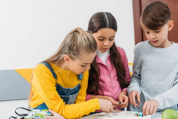 Concentrated Schoolchildren Making Robot Stem Lesson — Free Stock Photo