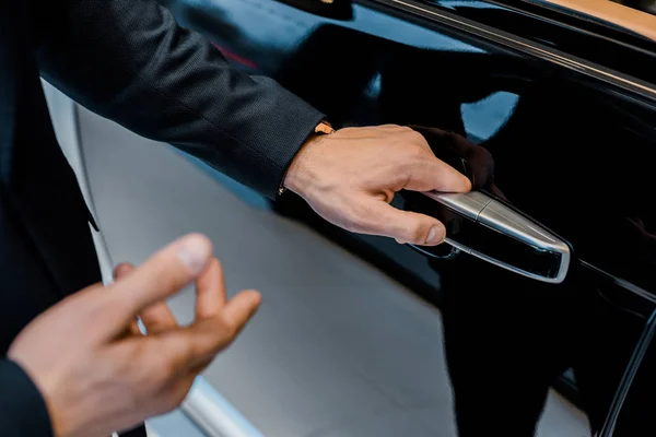 Partial View Male Car Dealer Opening Door Pointing Black Automobile — Stock Photo, Image