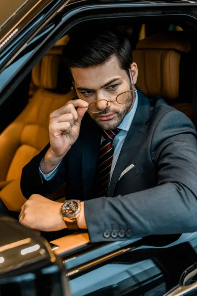 Stylish Businessman Luxury Watch Putting Eyeglasses While Sitting Car — Stock Photo, Image