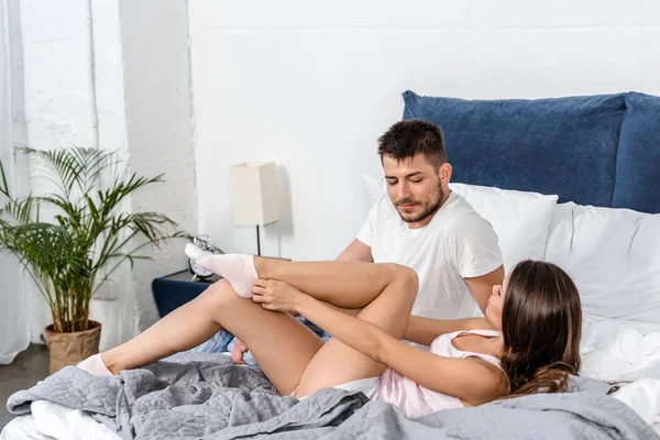 Girlfriend Lying Bed Wearing Socks Looking Boyfriend Pajamas Bedroom — Free Stock Photo