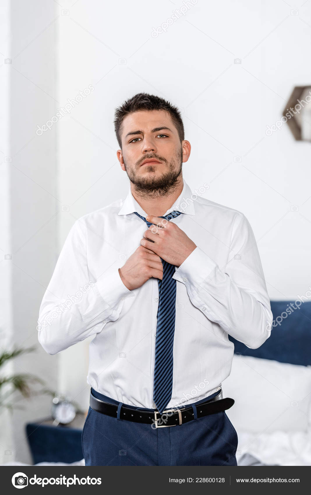 Handsome Man Tying Tie Morning Bedroom Looking Camera Stock Photo by