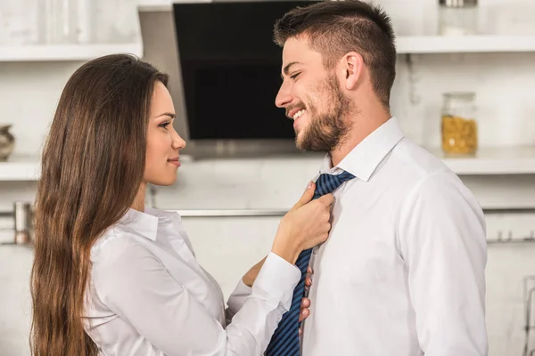 Portrait Girlfriend Tying Smiling Boyfriend Tie Morning Kitchen Sexism Concept — Stock Photo, Image