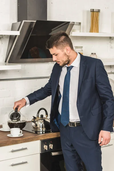 Handsome Man Suit Pouring Coffee Cup Morning Kitchen — Free Stock Photo