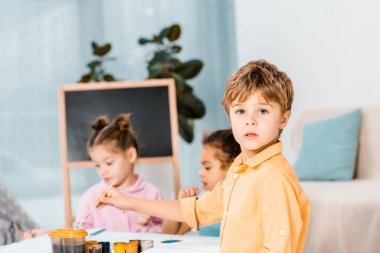arkadaş grubu resim yaparken kamera bakıyor tatlı küçük çocuk