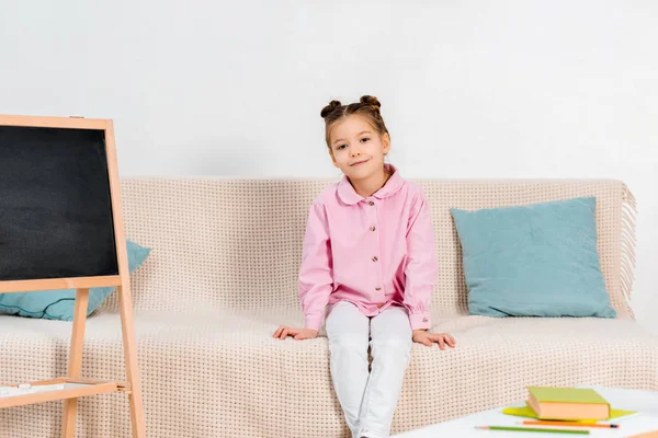 Vista Completa Hermosa Niña Sentada Sofá Sonriendo Cámara — Foto de Stock