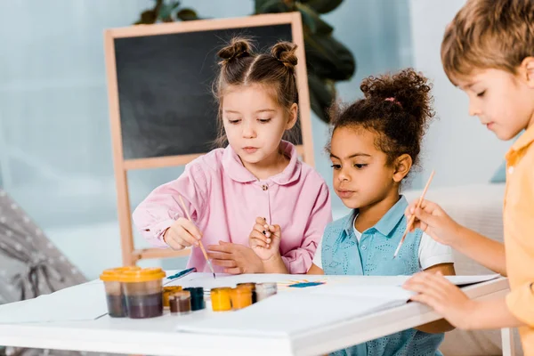 Adorable Little Multiracial Children Painting Together — Stock Photo, Image