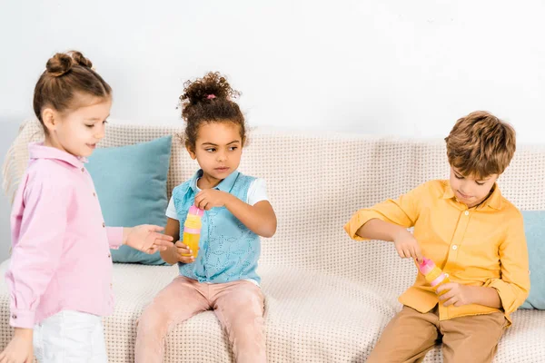 Cute Multiethnic Children Playing Soap Bubbles Together — Free Stock Photo