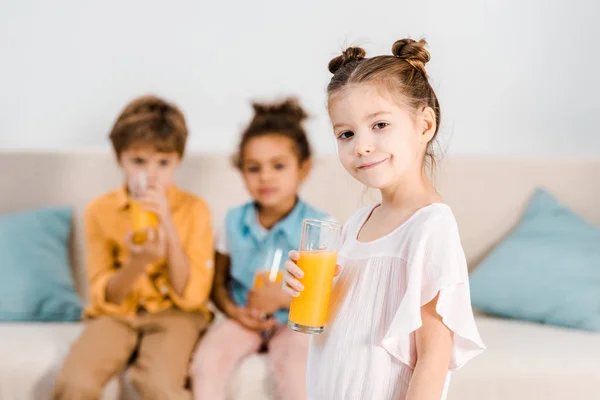 Adorable Child Holding Glass Juice Smiling Camera While Little Friends — Stock Photo, Image