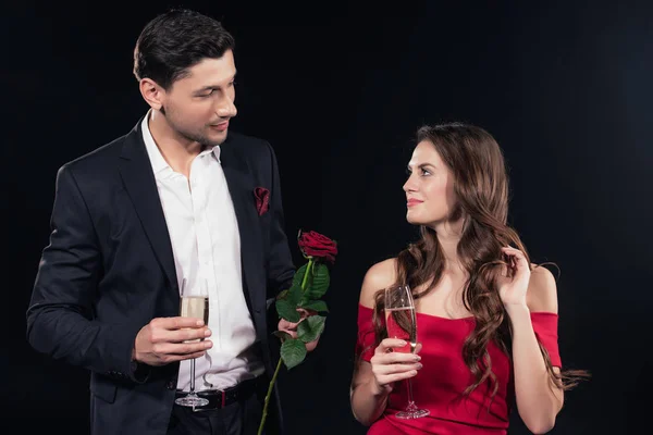 Beautiful Couple Looking Each Other Holding Red Rose Champagne Glasses — Free Stock Photo