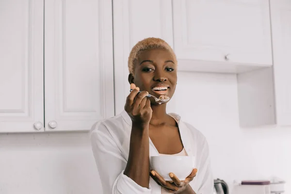 Cheerful African American Woman Eating Cornflakes White Kitchen — Stock Photo, Image