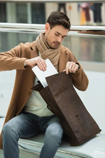 Handsome Man Sitting Bench Putting Laptop Bag — Free Stock Photo