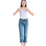 Mujer sonriente en jeans mostrando los pulgares hacia arriba aislado en blanco