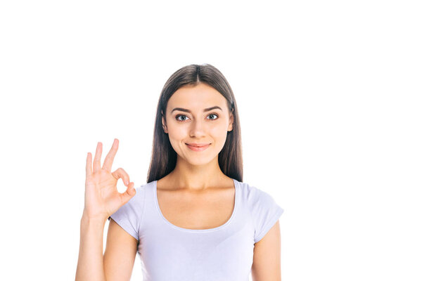 portrait of beautiful woman showing ok sign isolated on white