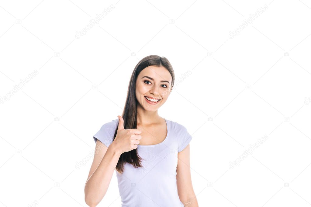 portrait of smiling young woman showing thumb up isolated on white