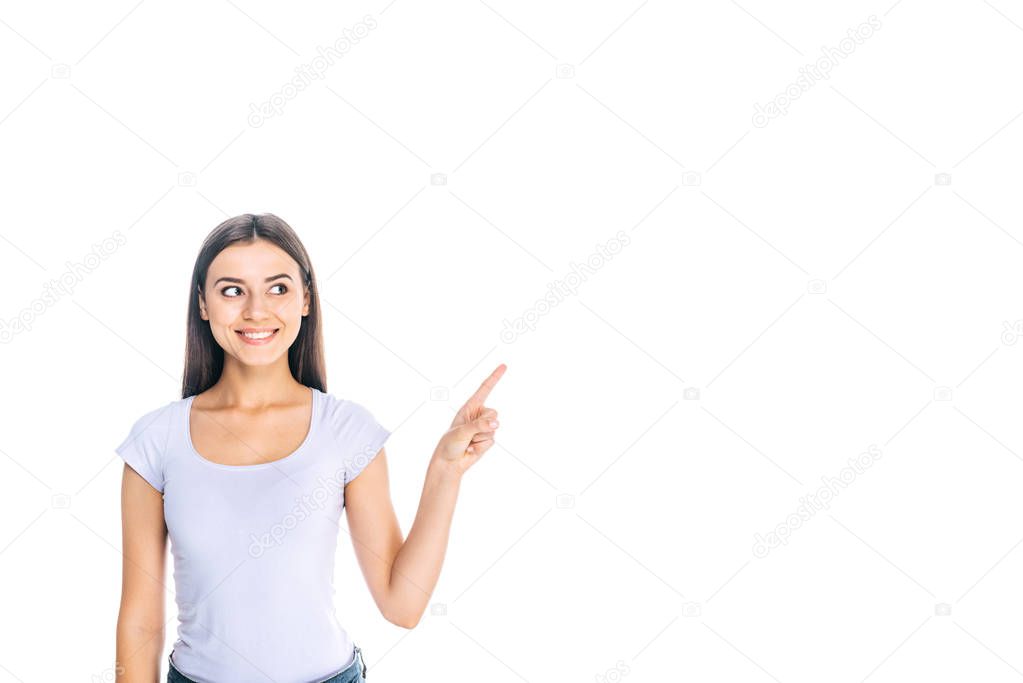 portrait of smiling young woman pointing away isolated on white