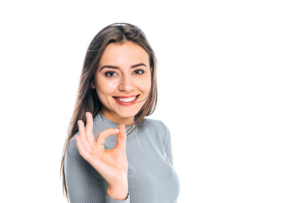 portrait of beautiful positive woman showing ok sign isolated on white