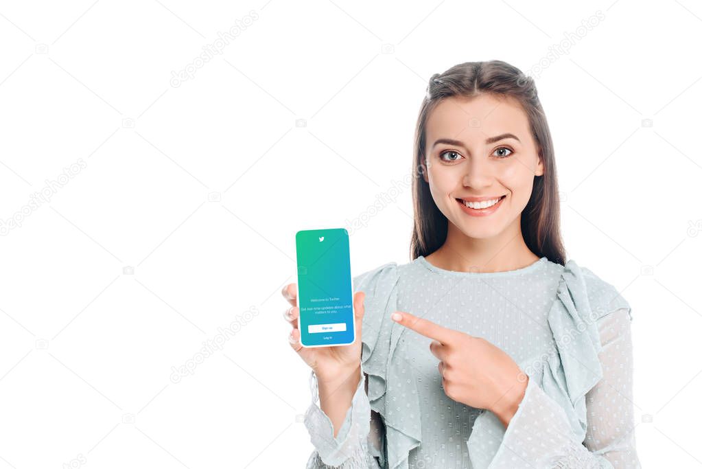 Smiling woman showing smartphone with twitter logo on screen isolated on white
