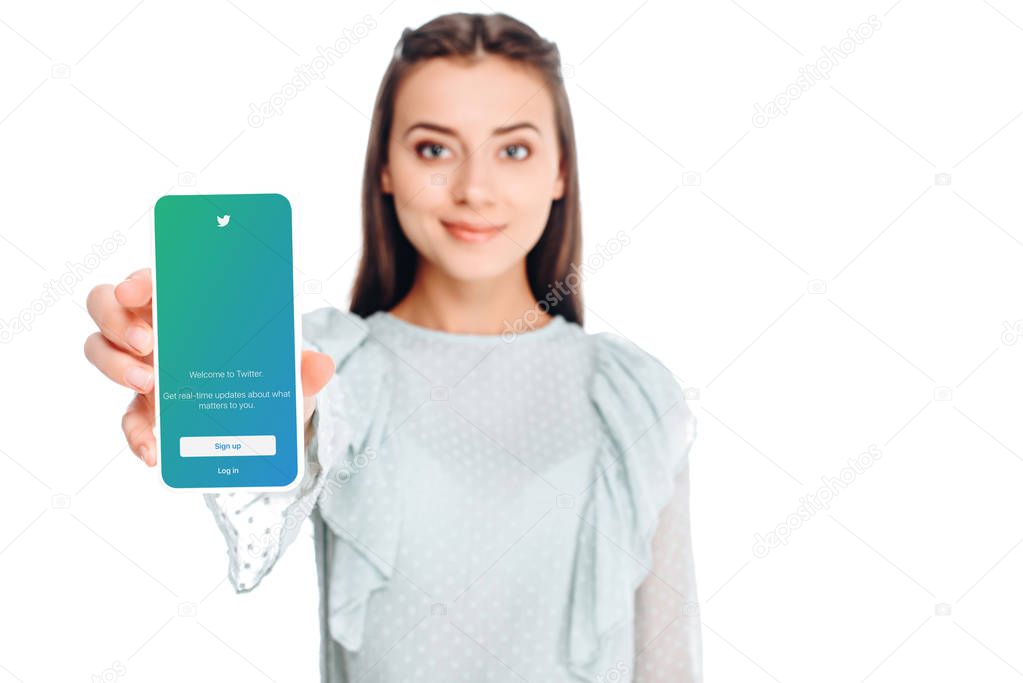 Young woman showing smartphone with twitter logo on screen isolated on white