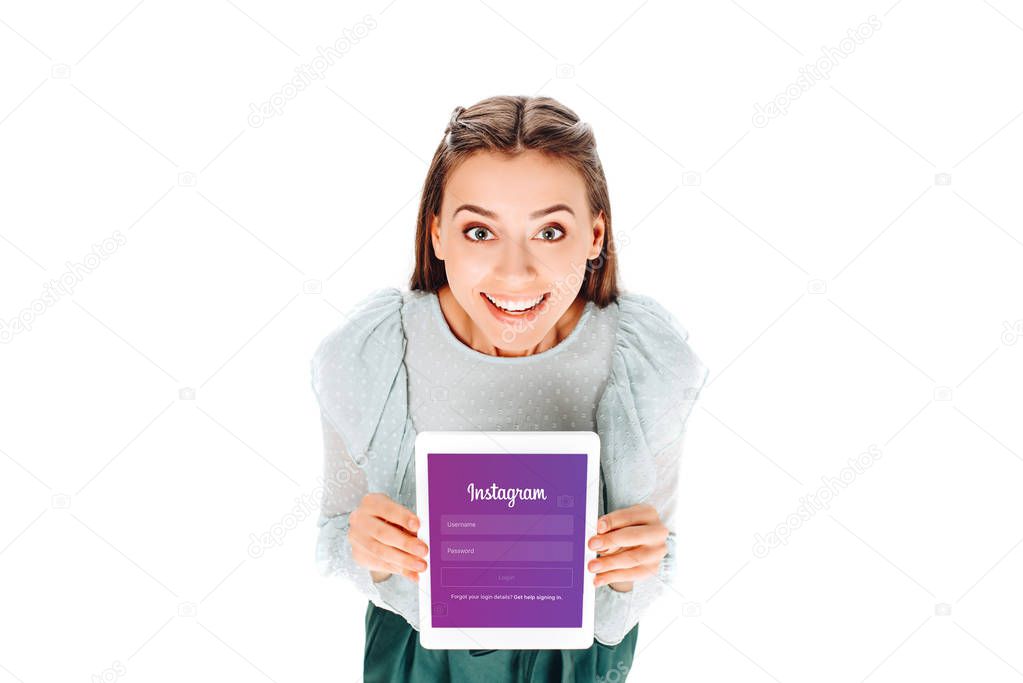 High angle view of smiling woman with tablet with instagram logo on screen isolated on white