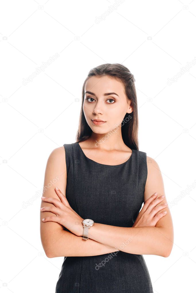 portrait of young woman in black dress with arms crossed isolated on white