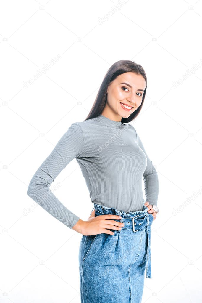 portrait of beautiful smiling woman akimbo looking at camera isolated on white
