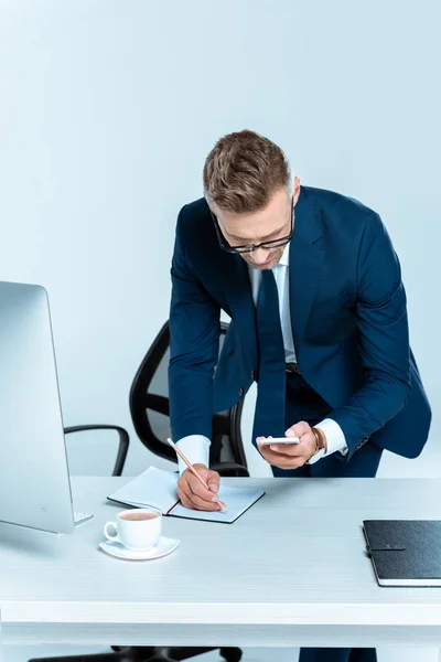 Handsome Businessman Looking Smartphone Writing Something Isolated White — Stock Photo, Image
