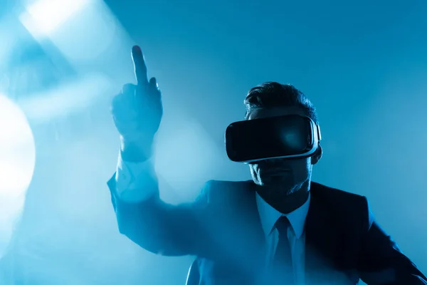 Businessman Virtual Reality Headset Pointing Something Isolated Blue Artificial Intelligence — Stock Photo, Image