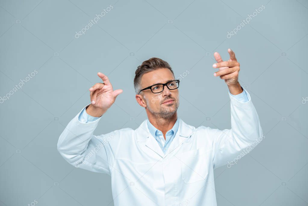 Handsome scientist in white coat and glasses moving something in air isolated on white, artificial intelligence concept