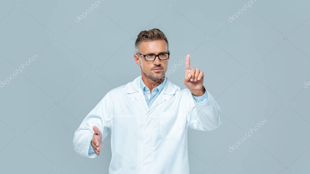 Handsome scientist in glasses touching something isolated on grey, artificial intelligence concept