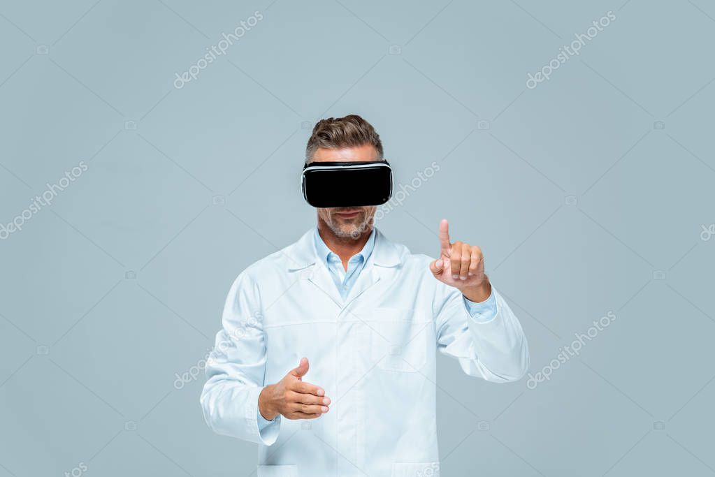Scientist in virtual reality headset moving something isolated on grey, artificial intelligence concept