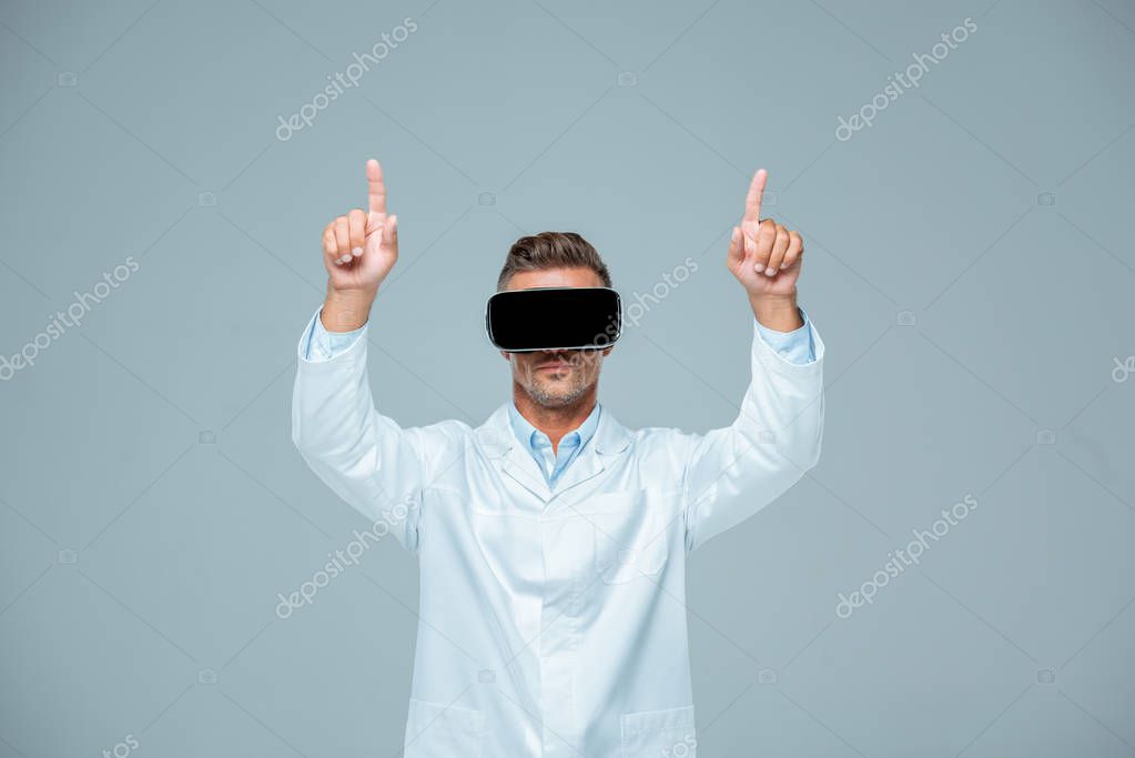 Scientist in virtual reality headset touching something with two fingers isolated on grey, artificial intelligence concept