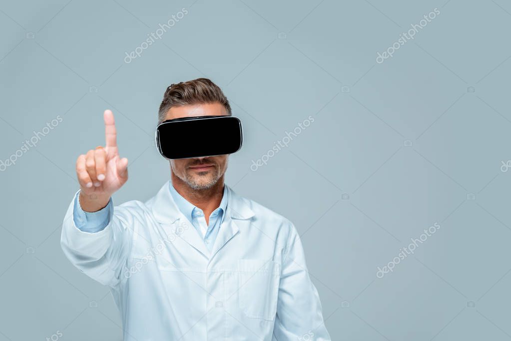 Scientist in virtual reality headset touching something with finger isolated on grey, artificial intelligence concept