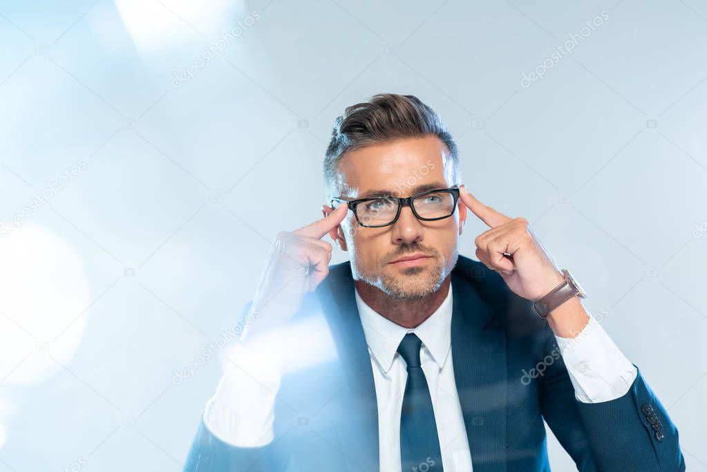 handsome businessman in glasses touching head isolated on white, artificial intelligence concept